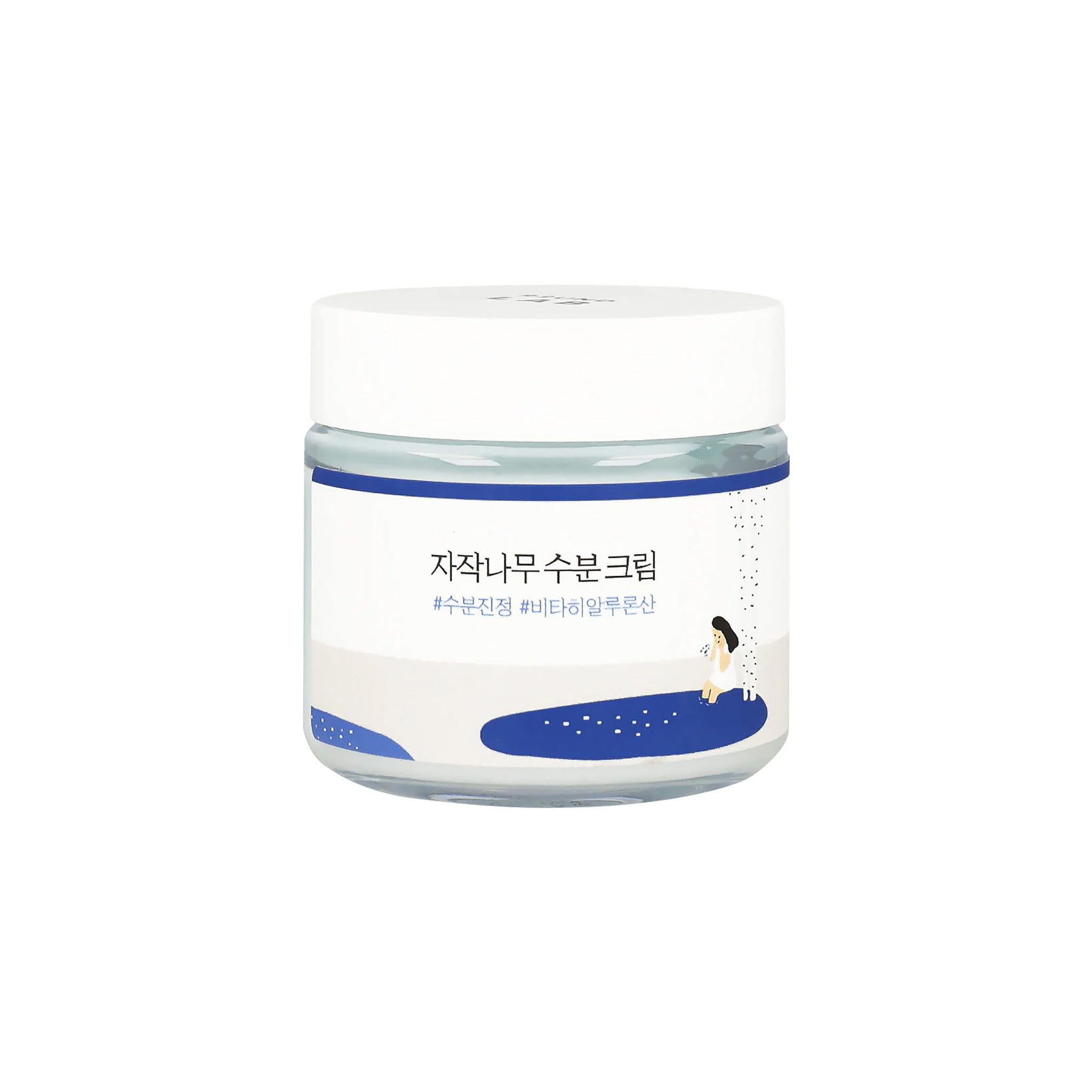 Frostet krukke med *자작나무 수분 크림* birkevandcreme med blå og hvidt design og illustration af kvinde ved sø.