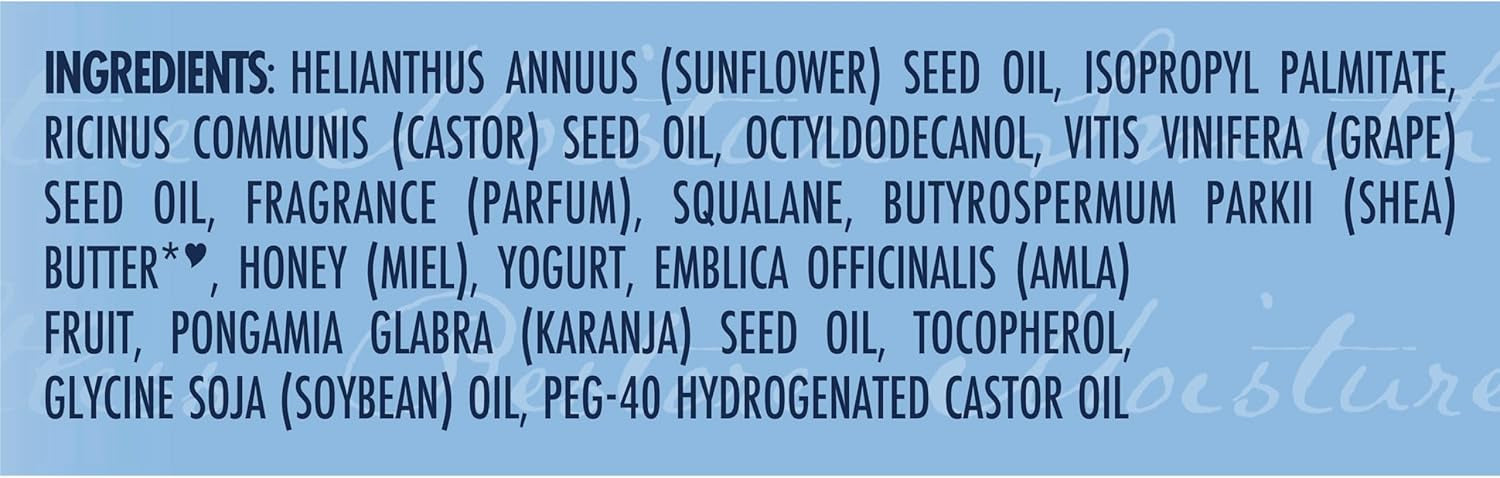 Ingrediensliste for Shea Moisture Manuka Honey & Yogurt Multi-Action Protect Oil på lyseblå baggrund med sort og blå tekst.