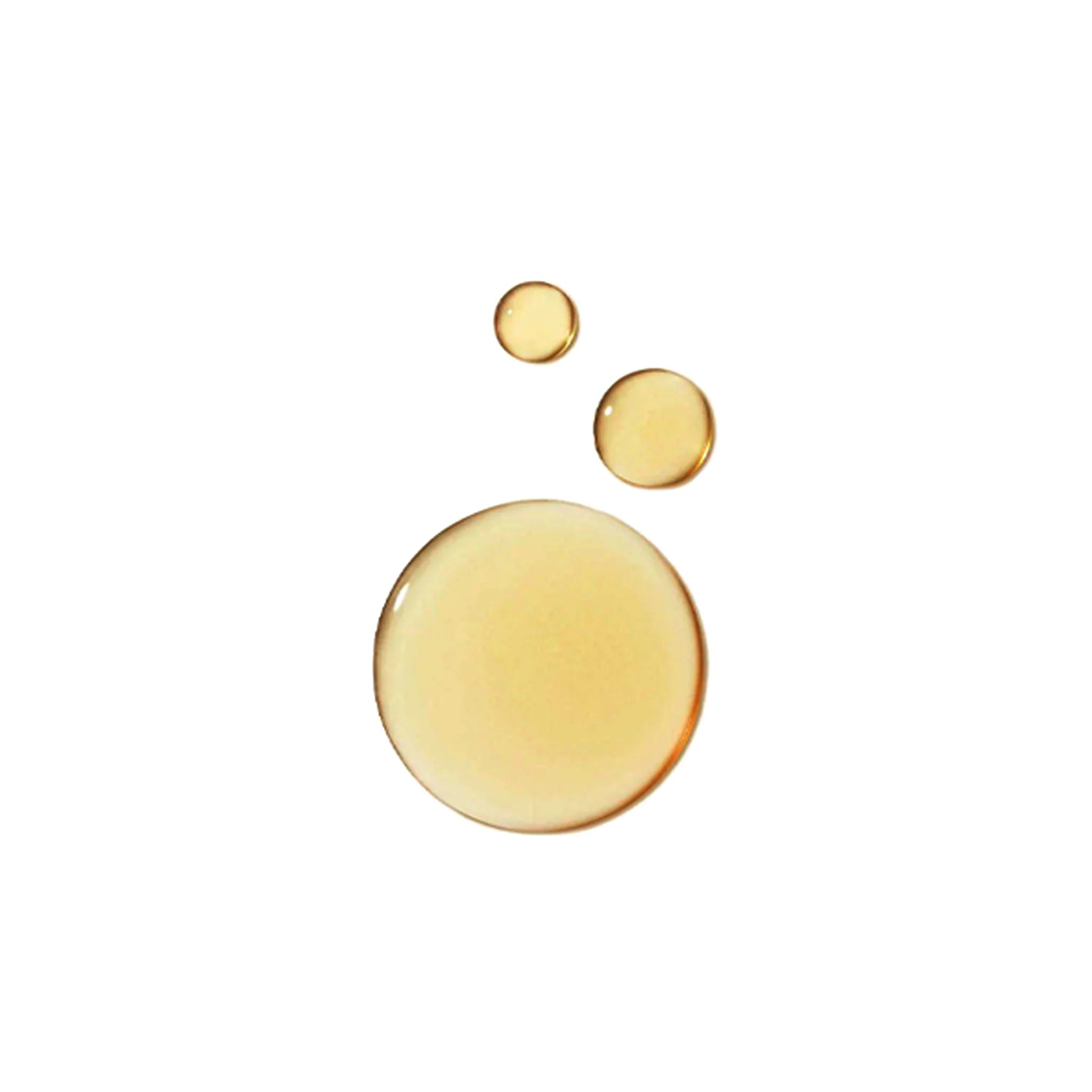 Tre gyldne oliedråber i forskellige størrelser mod hvid baggrund, symboliserer ren og letabsorberende olie.